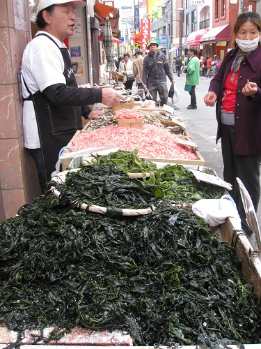 Vendor and shoppers on Jizo-dori